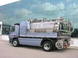 Excavator digging in heavy gumbo clay to replace a failed traditional septic drain field with an advanced aerobic system